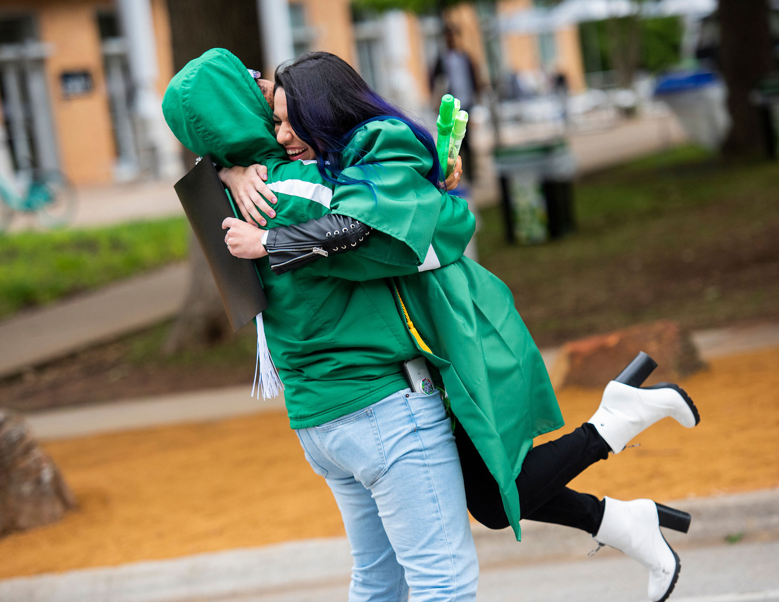 Parent and student hugging each other at UNT graduation. 